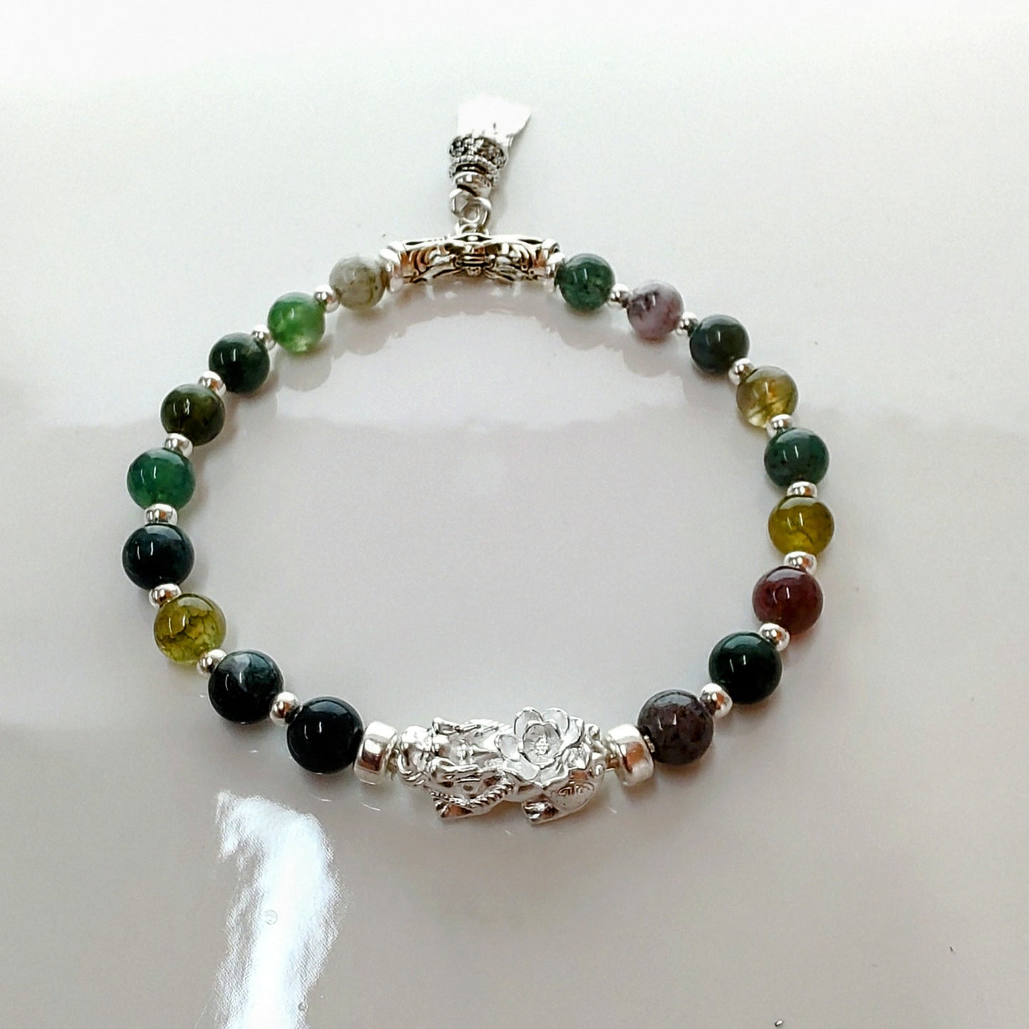 Introducing Sarah Lynn's stunning **Indian Agate Stretch Bracelet**, meticulously handmade with natural Indian agate beads and a pure silver charm featuring an enchanting mythical beast design. Each bead is selected for its unique, earthy colors and patterns, capturing the beauty of nature and spirituality.