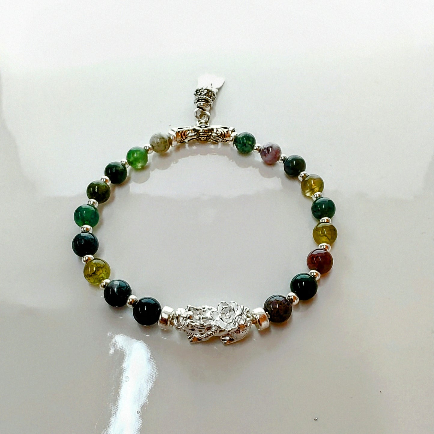 Introducing Sarah Lynn's stunning **Indian Agate Stretch Bracelet**, meticulously handmade with natural Indian agate beads and a pure silver charm featuring an enchanting mythical beast design. Each bead is selected for its unique, earthy colors and patterns, capturing the beauty of nature and spirituality.