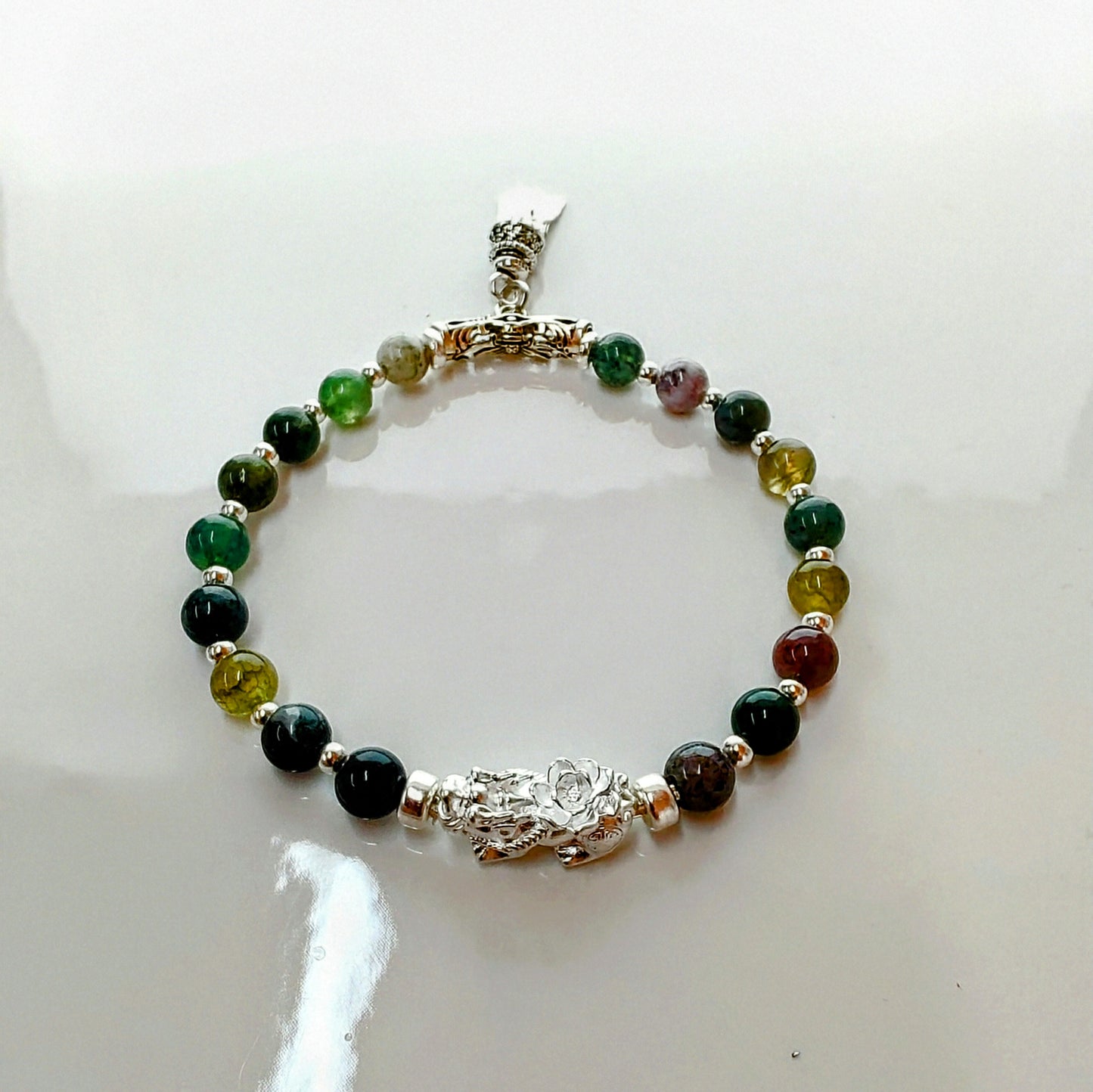 Introducing Sarah Lynn's stunning **Indian Agate Stretch Bracelet**, meticulously handmade with natural Indian agate beads and a pure silver charm featuring an enchanting mythical beast design. Each bead is selected for its unique, earthy colors and patterns, capturing the beauty of nature and spirituality.