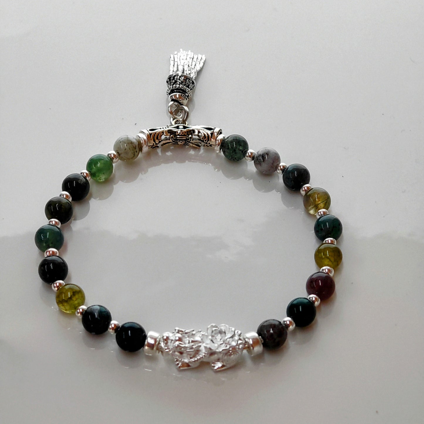 Introducing Sarah Lynn's stunning **Indian Agate Stretch Bracelet**, meticulously handmade with natural Indian agate beads and a pure silver charm featuring an enchanting mythical beast design. Each bead is selected for its unique, earthy colors and patterns, capturing the beauty of nature and spirituality.