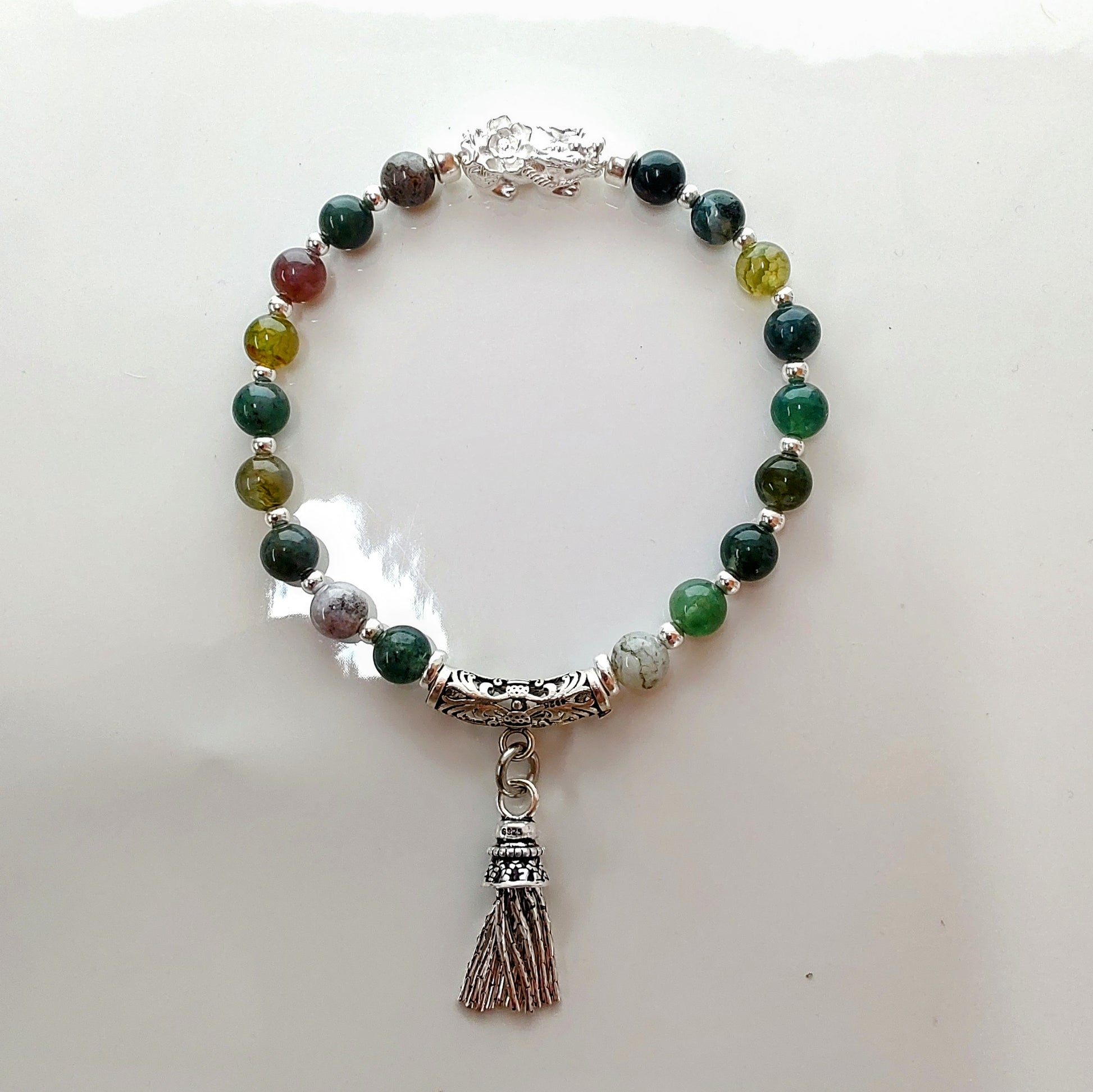 Introducing Sarah Lynn's stunning **Indian Agate Stretch Bracelet**, meticulously handmade with natural Indian agate beads and a pure silver charm featuring an enchanting mythical beast design. Each bead is selected for its unique, earthy colors and patterns, capturing the beauty of nature and spirituality. 